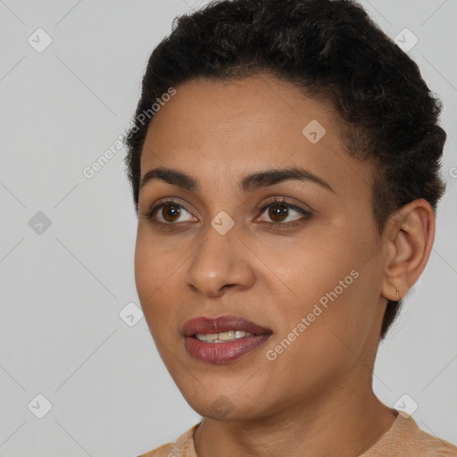 Joyful black young-adult female with short  black hair and brown eyes