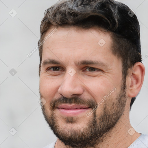 Joyful white adult male with short  black hair and brown eyes