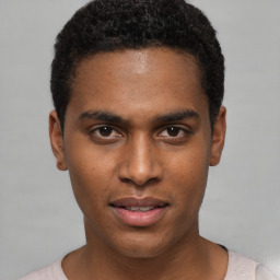 Joyful black young-adult male with short  black hair and brown eyes