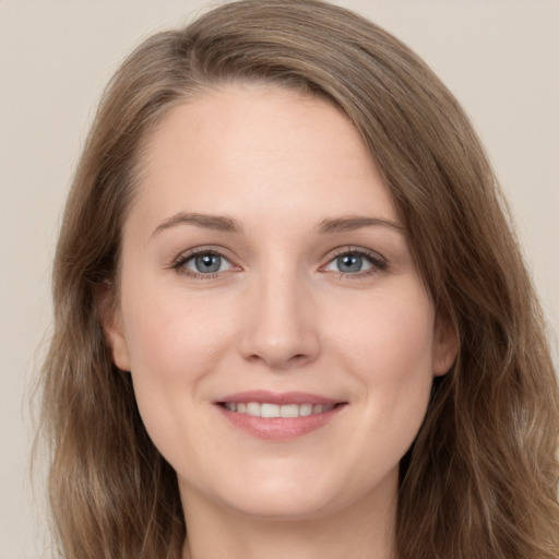 Joyful white young-adult female with long  brown hair and grey eyes