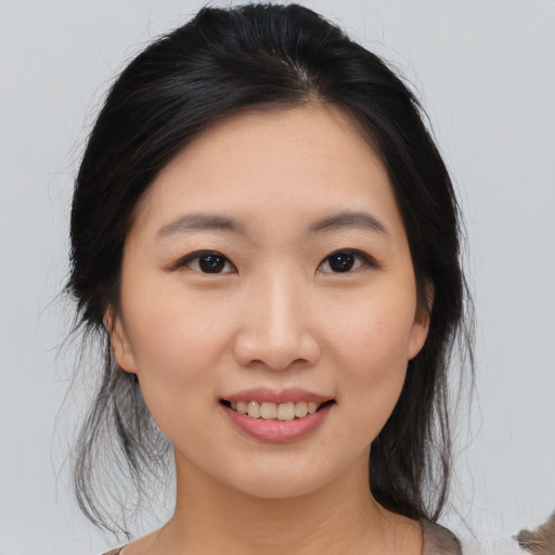 Joyful asian young-adult female with medium  brown hair and brown eyes