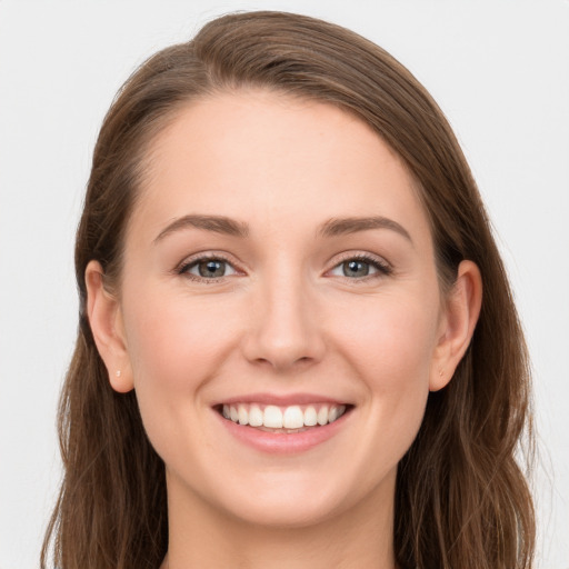 Joyful white young-adult female with long  brown hair and grey eyes