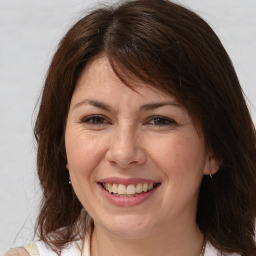 Joyful white adult female with medium  brown hair and brown eyes