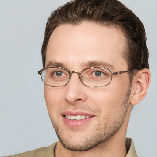 Joyful white adult male with short  brown hair and grey eyes