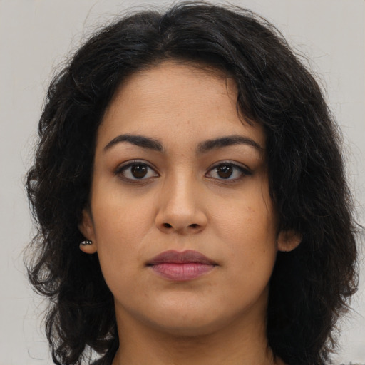 Neutral latino young-adult female with long  brown hair and brown eyes