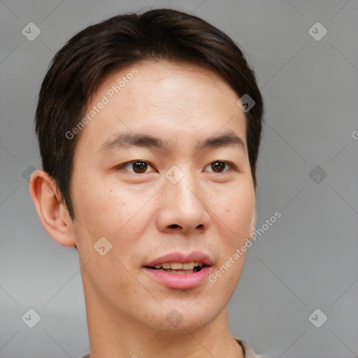 Joyful asian young-adult male with short  brown hair and brown eyes