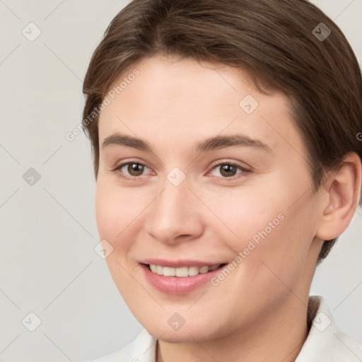 Joyful white young-adult female with short  brown hair and brown eyes