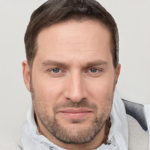 Joyful white adult male with short  brown hair and brown eyes