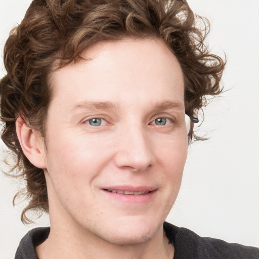 Joyful white young-adult male with medium  brown hair and blue eyes