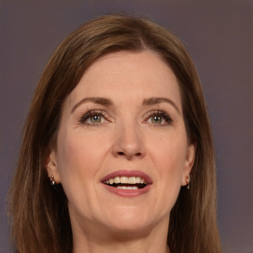 Joyful white adult female with long  brown hair and grey eyes