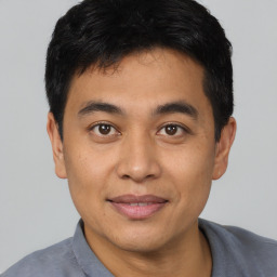 Joyful asian young-adult male with short  black hair and brown eyes