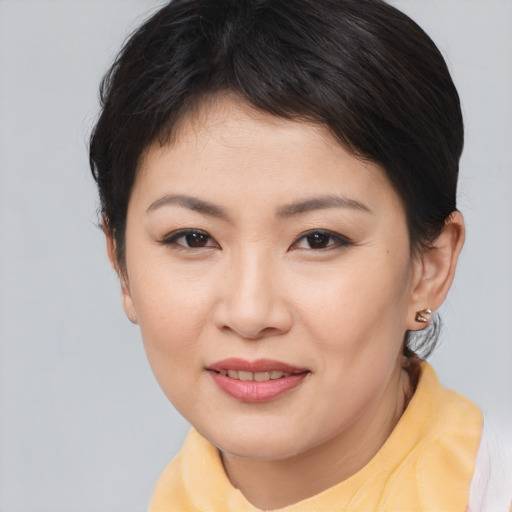 Joyful asian young-adult female with medium  brown hair and brown eyes