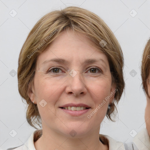 Joyful white adult female with medium  brown hair and blue eyes