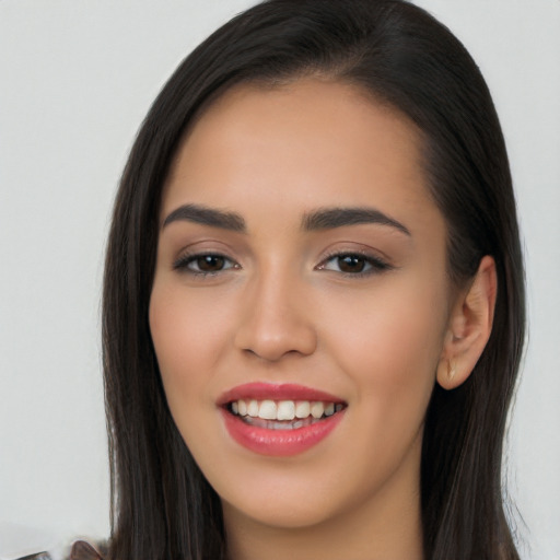 Joyful latino young-adult female with long  brown hair and brown eyes