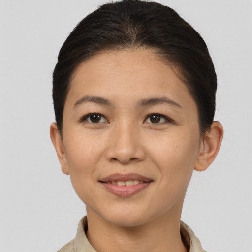 Joyful asian young-adult female with short  brown hair and brown eyes