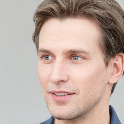 Joyful white adult male with short  brown hair and grey eyes