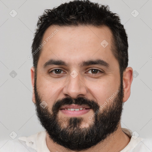 Joyful white young-adult male with short  black hair and brown eyes