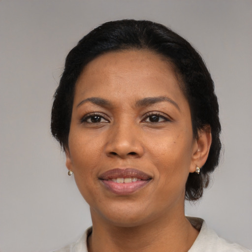 Joyful black adult female with medium  black hair and brown eyes