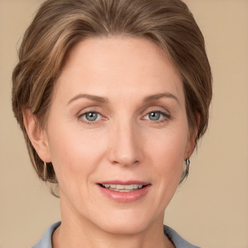 Joyful white adult female with medium  brown hair and grey eyes