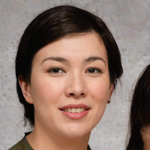 Joyful white young-adult female with medium  brown hair and brown eyes