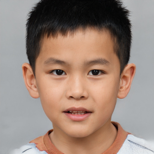 Joyful asian child male with short  brown hair and brown eyes