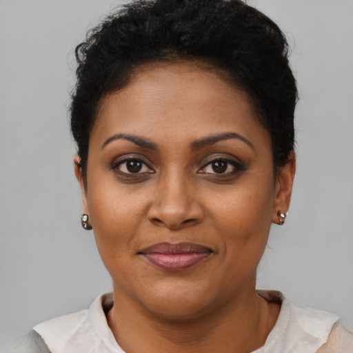 Joyful black young-adult female with short  brown hair and brown eyes