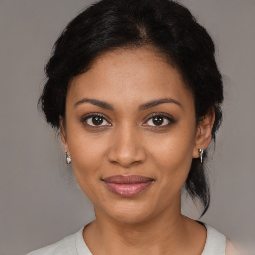 Joyful black young-adult female with medium  brown hair and brown eyes