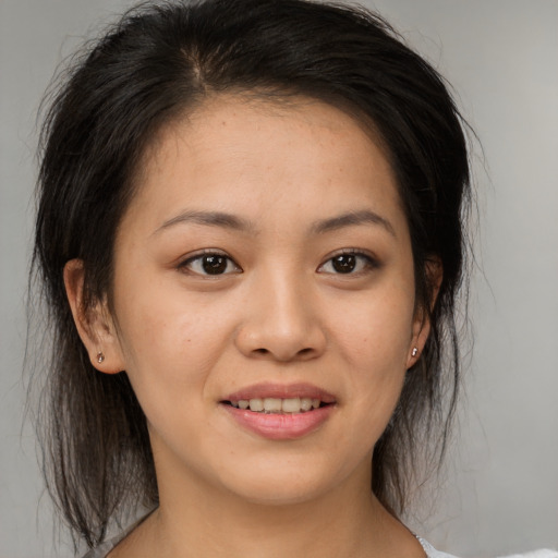 Joyful asian young-adult female with medium  brown hair and brown eyes