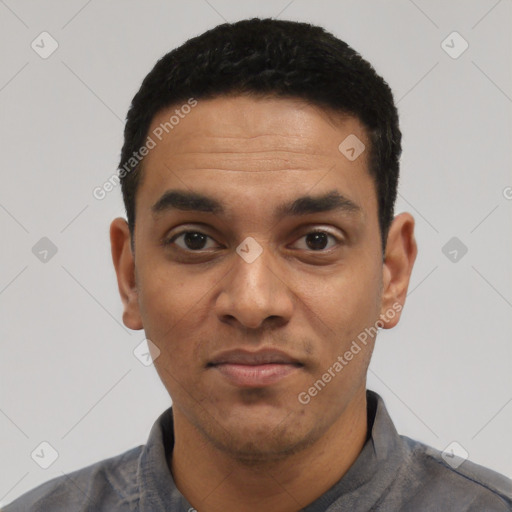 Joyful latino young-adult male with short  black hair and brown eyes