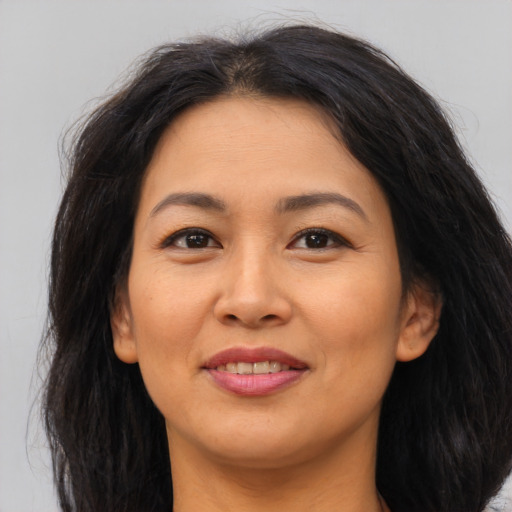 Joyful asian young-adult female with long  brown hair and brown eyes