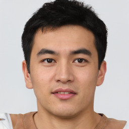 Joyful asian young-adult male with short  black hair and brown eyes