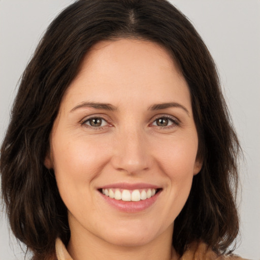 Joyful white young-adult female with medium  brown hair and brown eyes