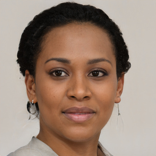 Joyful black young-adult female with short  brown hair and brown eyes