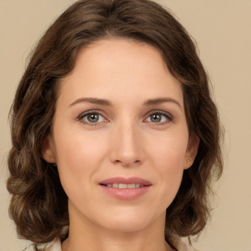 Joyful white young-adult female with medium  brown hair and green eyes