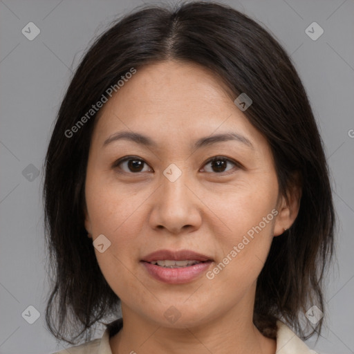 Joyful asian adult female with medium  brown hair and brown eyes