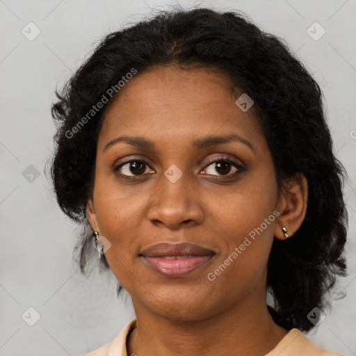 Joyful black adult female with medium  brown hair and brown eyes