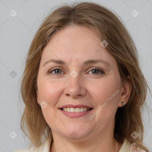 Joyful white adult female with medium  brown hair and grey eyes