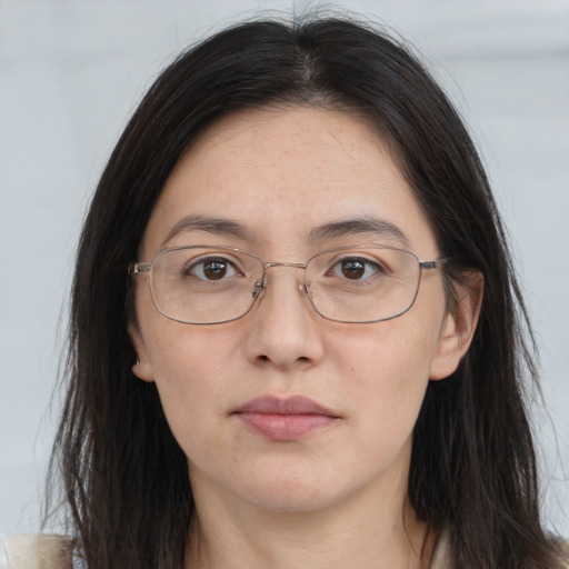 Joyful white adult female with long  brown hair and brown eyes