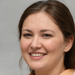 Joyful white adult female with medium  brown hair and brown eyes