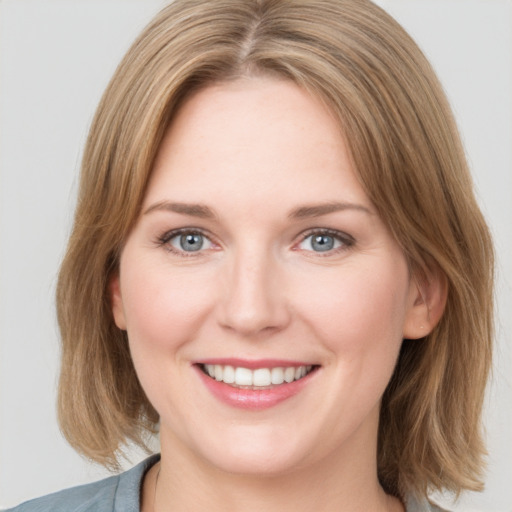 Joyful white young-adult female with medium  brown hair and blue eyes