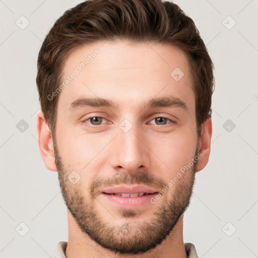 Joyful white young-adult male with short  brown hair and grey eyes