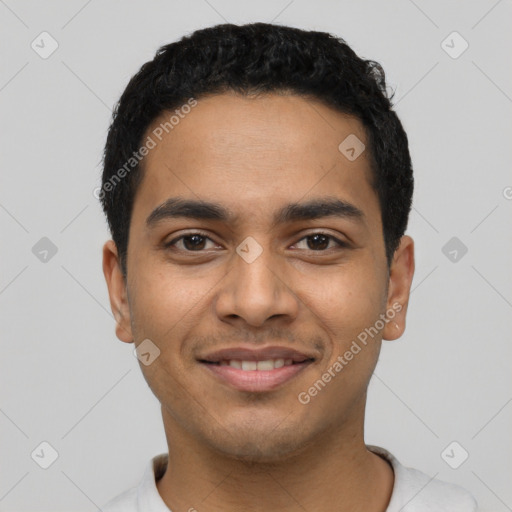 Joyful latino young-adult male with short  black hair and brown eyes