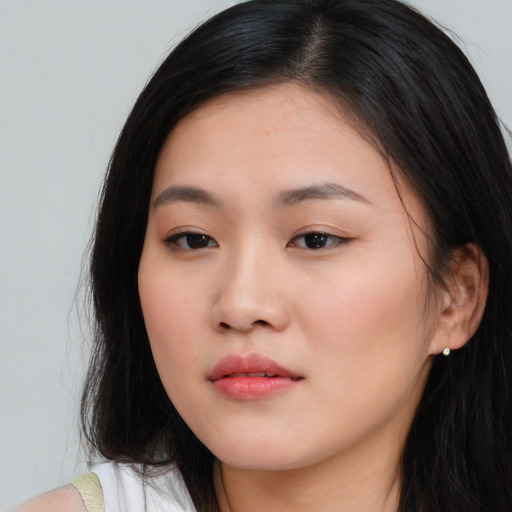 Joyful asian young-adult female with long  brown hair and brown eyes