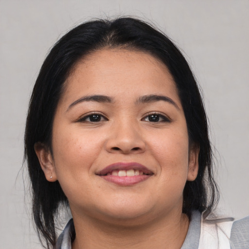 Joyful white young-adult female with medium  black hair and brown eyes