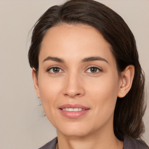 Joyful white young-adult female with medium  brown hair and brown eyes