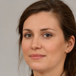 Joyful white adult female with long  brown hair and brown eyes