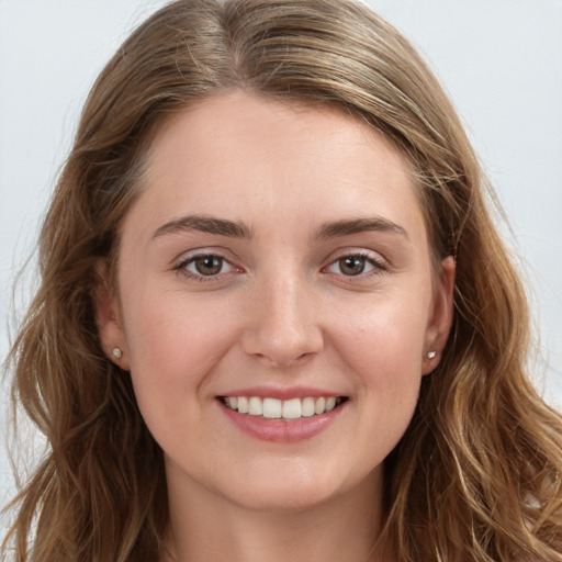 Joyful white young-adult female with long  brown hair and grey eyes