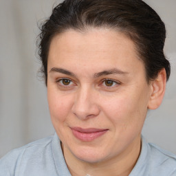 Joyful white adult female with medium  brown hair and brown eyes