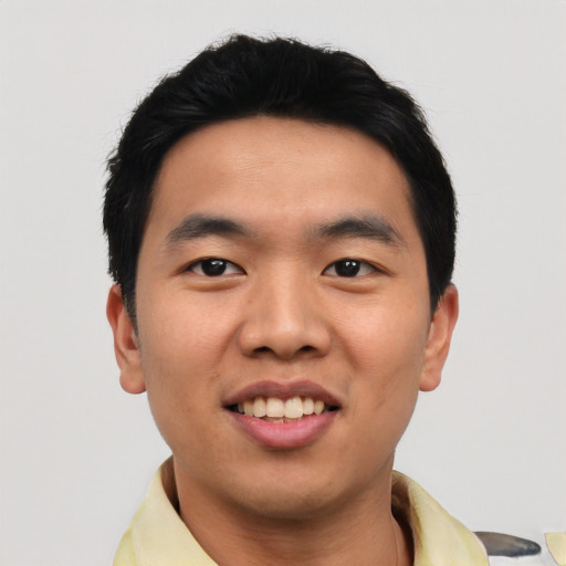 Joyful asian young-adult male with short  black hair and brown eyes