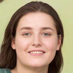 Joyful white young-adult female with long  brown hair and green eyes